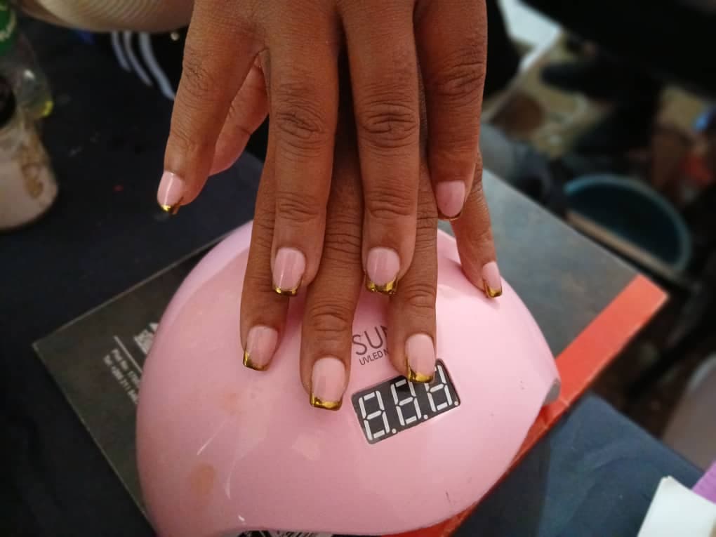 Gold French-tip gel manicure at Saylor Beauty Spa